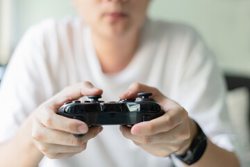 Young man hands holding joystick.Play the video game concept.