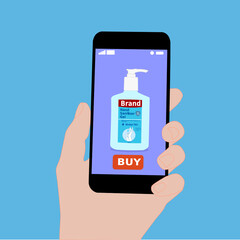 Hand holding smart phone with buy button on the screen. Contactless online purchase of goods using your phone. Use Hand sanitizer pump bottle. Home delivery.