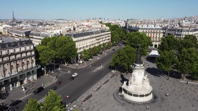 Flying over Republic square with Eiffel tower in background. Sky for copy space
