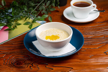 Millet porridge with butter and coffee for breakfast at home
