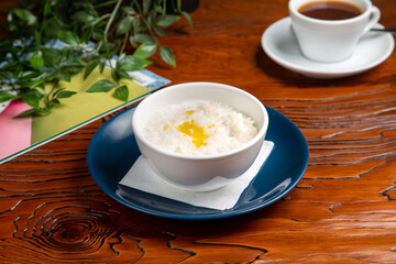 Rice porridge with butter and coffee for breakfast at home
