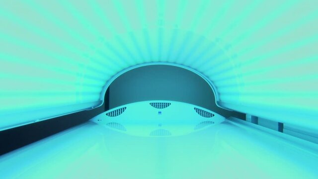 Inside bright blue tanning booth with lid closed and switched on, zooming out