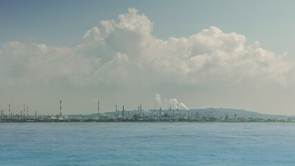 Naklejka premium Industrial landscape view from the ocean. Sea pollution and ecological problem