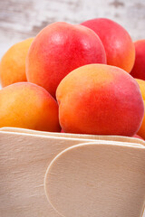 Fresh apricot in wooden box as healthy snack or dessert containing vitamins