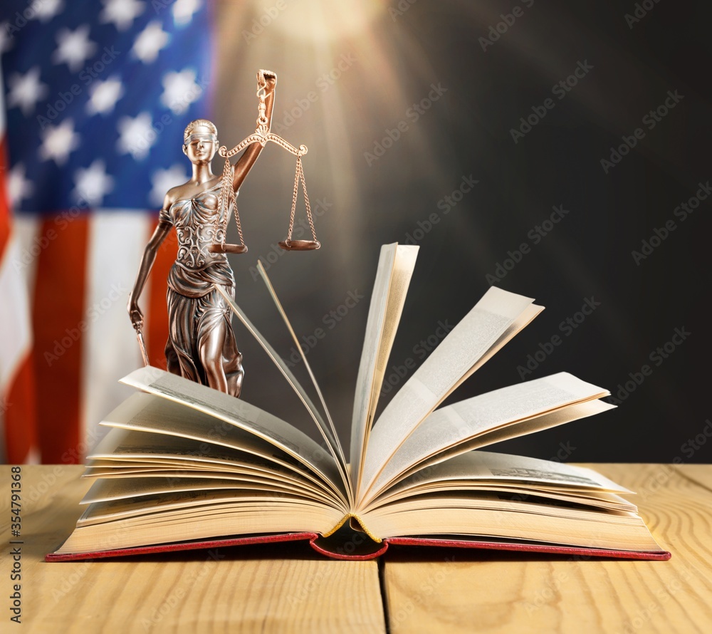 Wall mural old open book on a justice lady statue background
