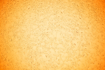 Rain droplets on yellow glass background, Water drops on yellow glass.