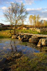 Fototapeta na wymiar Antique old roman stone bridge on the north of Spain 