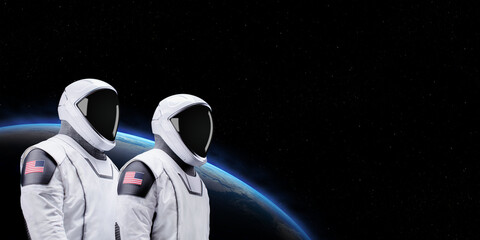 American astronauts on space mission with earth and outer space on the background. Elements of this...