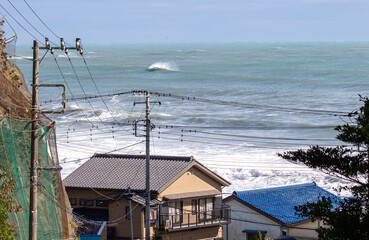 Fototapeta na wymiar Large Waves from Typhoon, Hurricane, breaking, climate & ocean temperatures are rising, Surfing In Japan, Near Shidashita, Olympic Venue for surf.