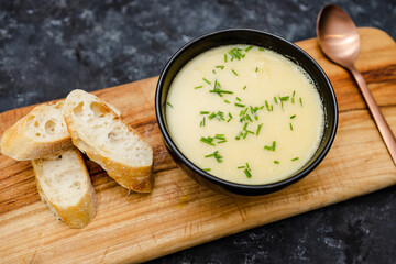 plant-based food, vegan corn cauliflower soup with chives topping and bread slices