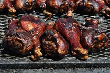 Turkey legs roasting on a grill at the county fair
