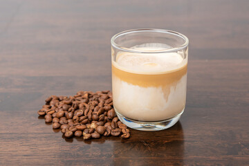 coffee latte with coffee bean on wooden table.