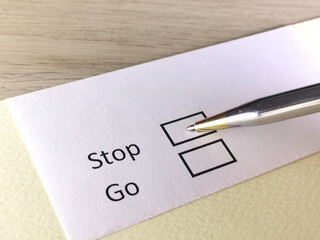 One person is answering question on a piece of paper. The person is thinking to stop or to go.