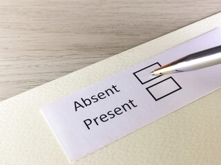 One person is answering question on a piece of paper. The person is thinking to be absent or present.