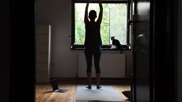 woman doing yoga at home