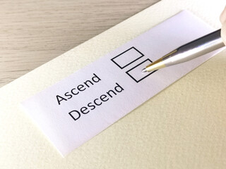One person is answering question on a piece of paper. The person is thinking to ascend or descend.