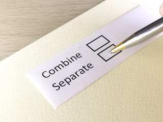 One person is answering question on a piece of paper. The person is thinking to combine or to seperate.