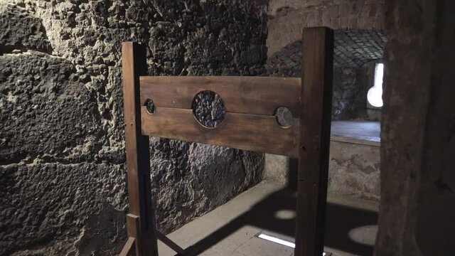 A terrifying wooden medieval torture equipment inside a real stone castle medium shot
