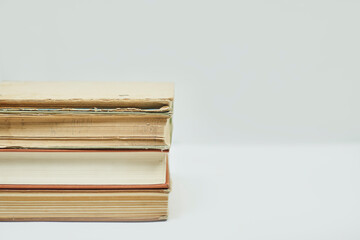 Online education or distance education concepts. Stack of old books on white with copy space