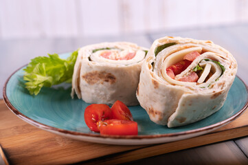 Turkey Roll Ups with cheese and vegetables,
Close-up of delicious appetizer.
Tortilla pieces.