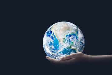 Ecology Concept : Hand holding blue planet earth in dark room. (Elements of this image furnished by NASA.)