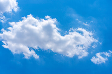 Naklejka na ściany i meble Big white cloud floating on vast blue sky in beautiful weather