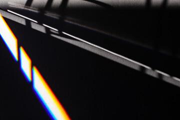 Black futuristic shadows and bright light refraction glow effect with colorful rainbow. Black noir...