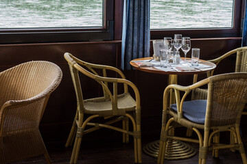 table with glasses and armchairs on a ship