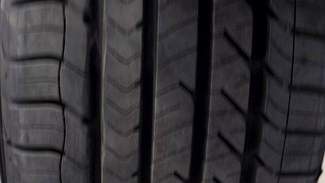 Used rubber car wheel tire turning around fast, close up