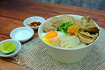 Vietnamese rice noodle soup with pork spare ribs, Vietnamese sausage, mince, minced pork, Shiitake mushrooms and Onsen tamago or soft-boiled/hot spring eggs (Kuey Jab Yuen) served with condiments.