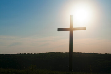 Wooden cross against the sky and sunrise. Death of jesus