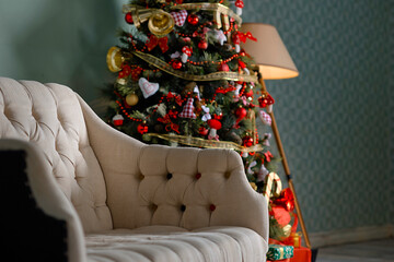 Christmas tree with garlands, vintage toys and decorative fireplace in studio.