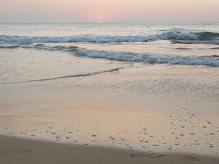 The sunset capture in the beach at a beautiful evening with sea waves