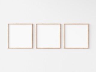 Three square thin wooden frame on white wall. 3d illustration.