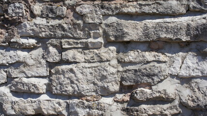 old stone wall masonry made of natural limestone stone beautiful textured background gray