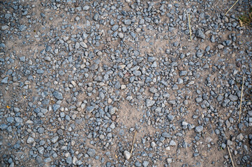 A high angle shot of the ground covered in small stones at daytime