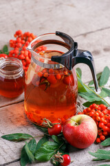 Hot tea from rosehip berries and fruit in transparent glasses and honey on a wooden table. Harvesting, autumn fall winter hot warming tea, immunity beverage