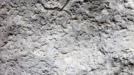 Stone rock texture or background. Gray rocky uneven surface, natural seamless backdrop for design. Copy space