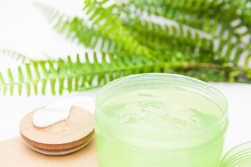 closeup cosmetic aloe gel bowl with green leaves