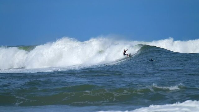 A surfer rides powerful ocean wave at the famous North Shore on Oahu in Hawaii