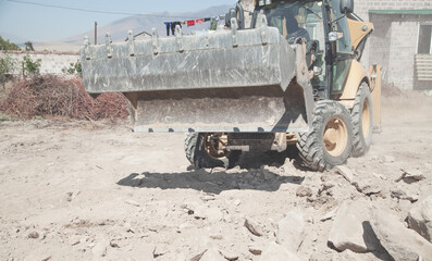 Excavator works at a construction site.