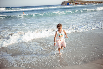 happy  little girl have fun and joy time at beautiful beach