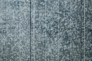 Tin fence with a beautiful textured pattern.