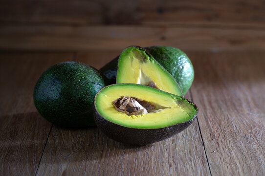 Pile of avocados put on brown wooden table