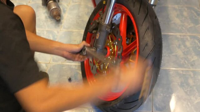 Close-up Footage of Mechanic Working On Motorcycle Wheels Installation