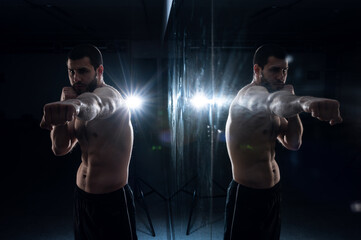  boxer training in the gym with reflection in low key photo for fight club advertisement