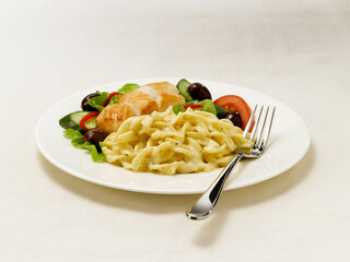 Pasta with chicken and salad