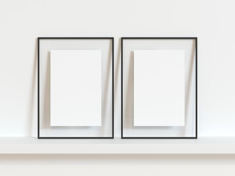 Two vertical black thin empty frame mock up on white wall. 3d illustration.