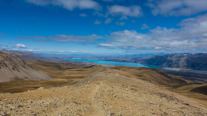 Fototapeta na wymiar New Zealand tussock mountain landscape with view of Lake Tekapo