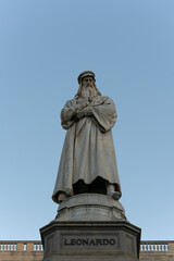 The Statue of Leonardo da Vinci on clear blue sky in Milano, Italy.
